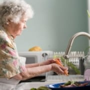woman-at-sink-cleaning-vegetables