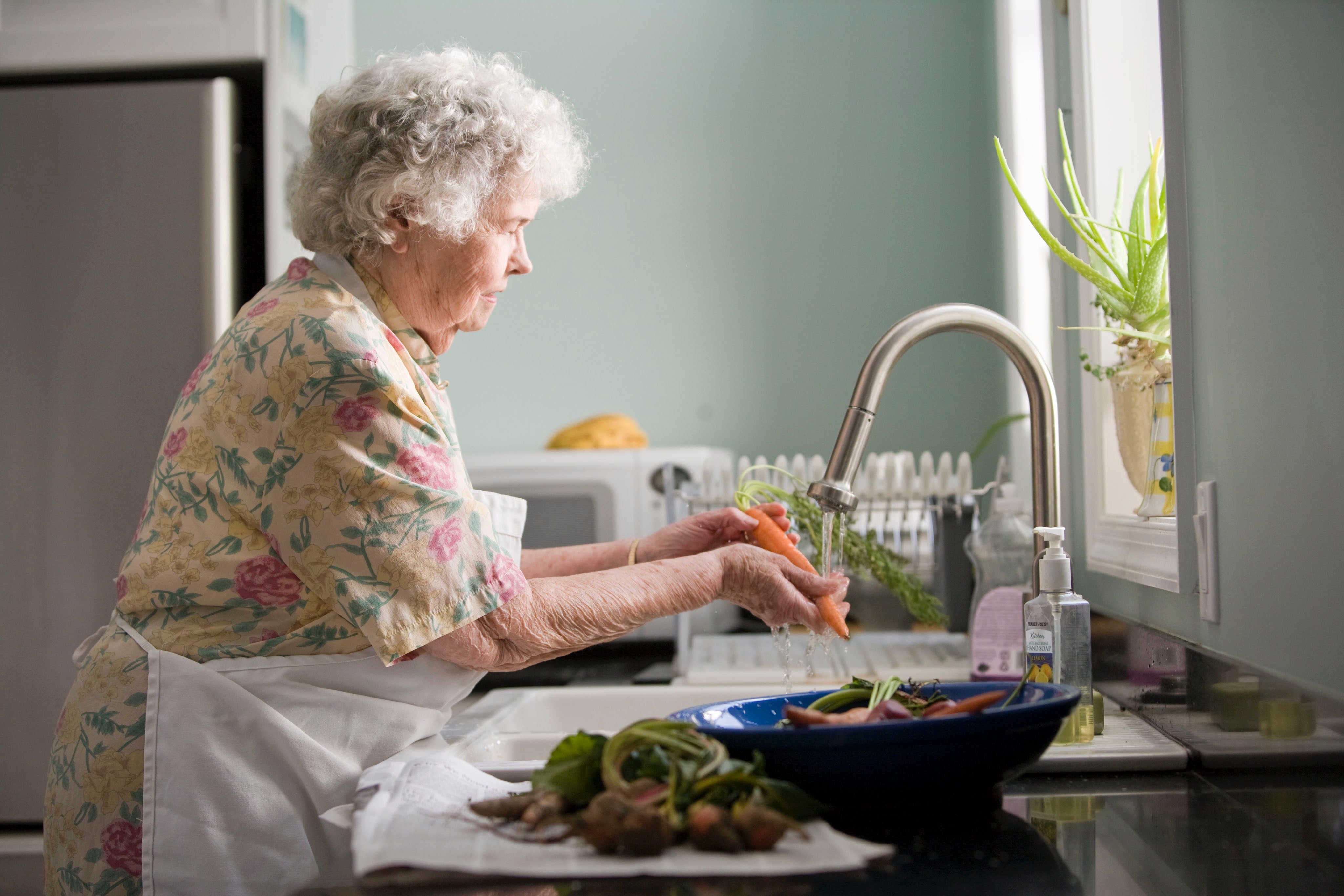 woman-at-sink-cleaning-vegetables