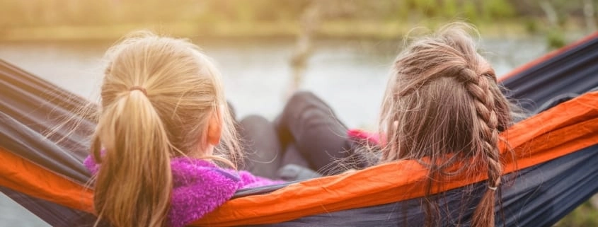 kids enjoying quiet time in hammock